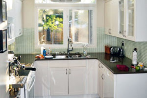 Before Kitchen Renovation photo of late 1990’s classic white kitchen from the Superior Cabinets AZUERA project.