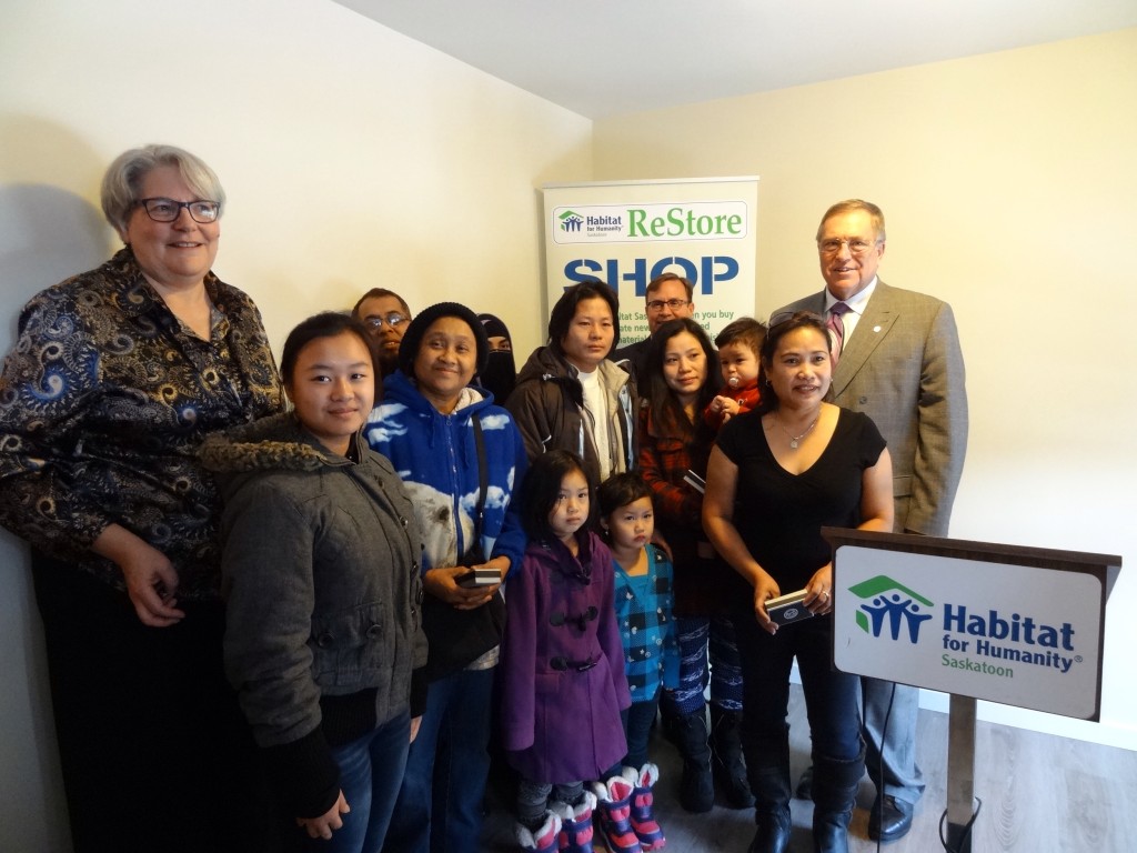 Habitat for Humanity Home Dedication, 119 Avenue S South, Saskatoon Saskatchewan. Photo featuring His Worship Mayor Don Atchison, Rob Norris MLA Saskatoon Greystone, Barb Cox-Lloyd President and CEO of Habitat for Humanity Saskatoon and the four families receiving the keys to their new homes.