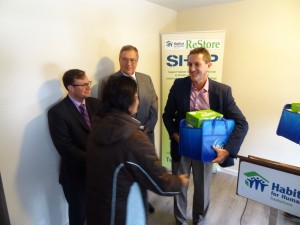 Habitat for Humanity Home Dedication, 119 Avenue S South, Saskatoon Saskatchewan. James Neufeld General Manager of Superior Cabinets Saskatchewan. Also featured are His Worship Mayor Don Atchison and Rob Norris MLA Saskatoon Greystone. James Neufeld General Manager of Superior Cabinets Saskatchewan presents a P&G cleaning package to a new Habitat for Humanity home owner.