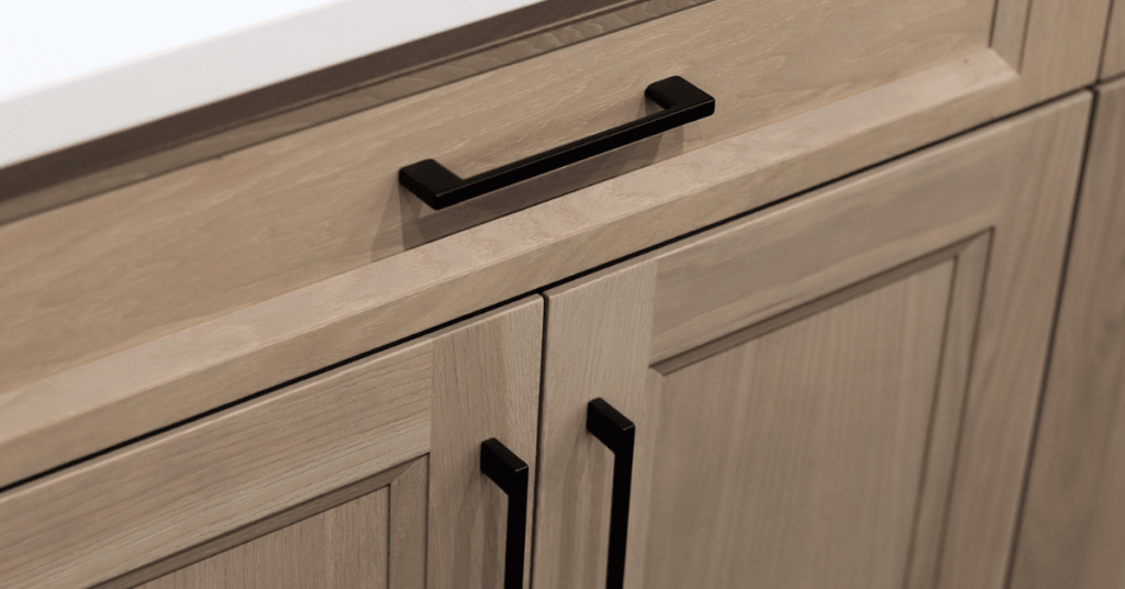 Rift cut white oak cabinets with matte black handles all by superior cabinets. 